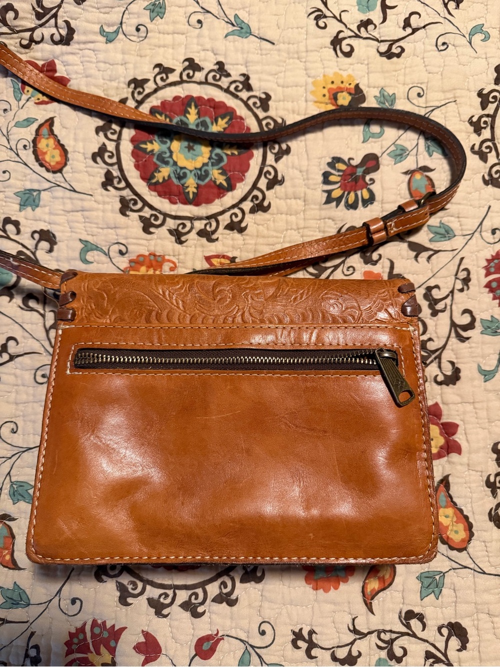 Patricia Nash Cognac Tooled Leather Crossbody
Dimensions: 7.5"W x 5.5"H x 2"D - Picture 2 of 2